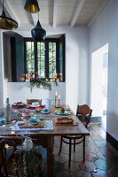 Festively set table in simple, rustic interior