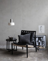 Masculine seating area against grey wall on concrete floor