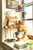 Mixer and hanging storage baskets in rustic kitchen