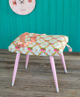 Stool with seat covered in floral fabric