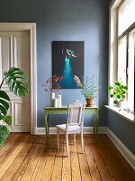 Antique chair at green console table against blue wall in period building