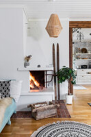 Fire in open corner fireplace in Scandinavian-style living room