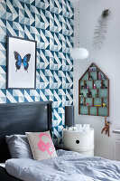 Wallpaper with graphic pattern in child's bedroom decorated in blue and grey
