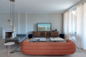 Chaise longue, suede sofa and TV cabinet in elegant living room