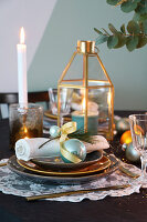 Dining table festively set in gold and turquoise