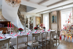 Table festively set in red and white in elegant interior