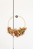 Golden ring decorated with dried hydrangeas