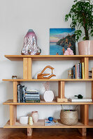 Books and decorative objects on a wooden shelf