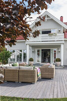 Elegant outdoor furniture on wooden terrace