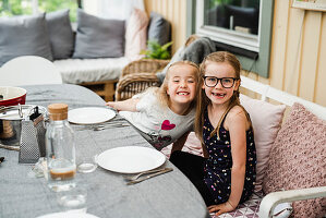 Zwei Mädchen beim Essen auf der Terrasse