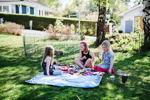 Girls having picnic in garden