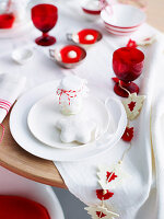 Christmas table with red and white tablecloth and guest gift