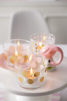 Glasses for tea lights decorated with gold dots