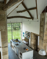 Kitchen island with limestone counter top in a converted barn