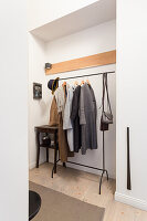 Clothes rack in niche in hallway