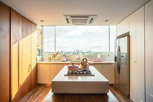 Kitchen with island counter and refrigerator