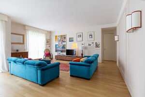 Blue upholstered sofas, TV furniture and rocking chair in the living room