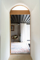 View through arched door into bedroom