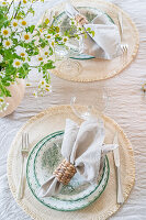 Place setting with green and white porcelain plates, linen napkin and napkin ring