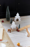 Christmas decoration with fir trees and deer on wood