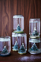 DIY snow globes made of preserving jars with fir trees