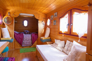 Seating and sleeping areas in traditional wooden caravan