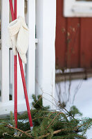 Winter decoration with ski poles and woolen mittens