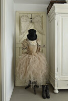 Antique clothes with tutu and top hat on a dressmaker's dummy