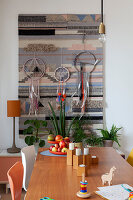 View over dining table to tapestry and dreamcatcher