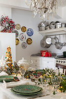 Dining table set for Christmas, chandelier and wall plates