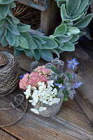 Bouquet of stonecrop, borage and hydrangea next to wreath of lamb's-ear