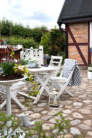 White painted garden furniture on a stone patio