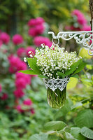 Lily-of-the-valley bouquet in suspended glass jar