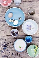 Various bowls with flowers and eggs as Easter decoration