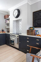 Kitchen base cabinets with grey fronts, cooker in wall niche