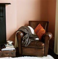 Brown leather armchair in the corner of a living room