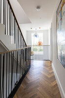 Parquet landing with double height atrium in sustainable newbuild Highgate London UK