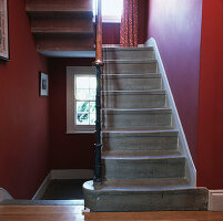 Stone Staircase in deep red painted hallway