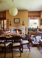 Antique chairs with embroidered silk seats around set dining table