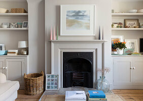 Living room with fireplace, white fitted wardrobes and decorative elements