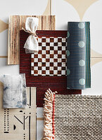 Mood board with various patterned fabrics and floor coverings