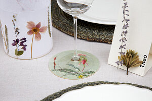 Floral table decoration with name cards, lantern and coasters