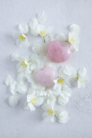 Two pink rose quartz hearts on jasmine flowers (affairs of the heart)