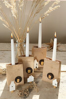 Alternative DIY advent wreath made of milk cartons with little paper houses