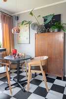 A breakfast nook with a round table and chairs in a kitchen