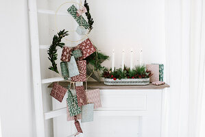 DIY candle bowl for Advent, packages hung next to it