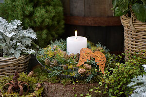 Wreath made of conifer greenery and larch branches, decorated with a candle