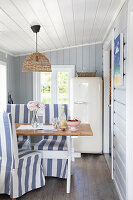 Dining area with blue and white cushion chairs in the beach cottage