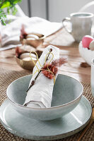 Easter table place setting with napkin rings in the shape of bunnies