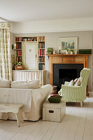 White sofa and green-white checked wing chair in the living room